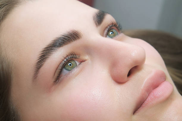 Close-up of a woman's face showcasing full, thick eyebrows, illustrating eyebrow regrowth potential.